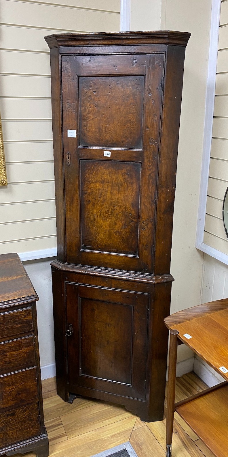 A 18th style oak standing corner cabinet, width 66cm, depth 34cm, height 190cm
